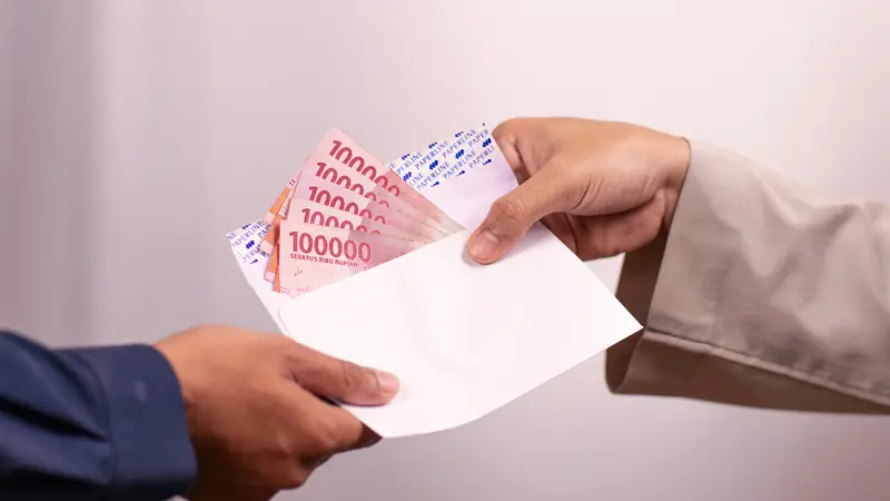 Stack of documents beside a laptop in an office
